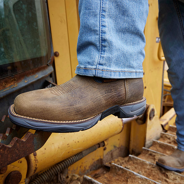 A Man Wearing the Bartlett 11" Pull-On Steel Toe Work Boots in Grey